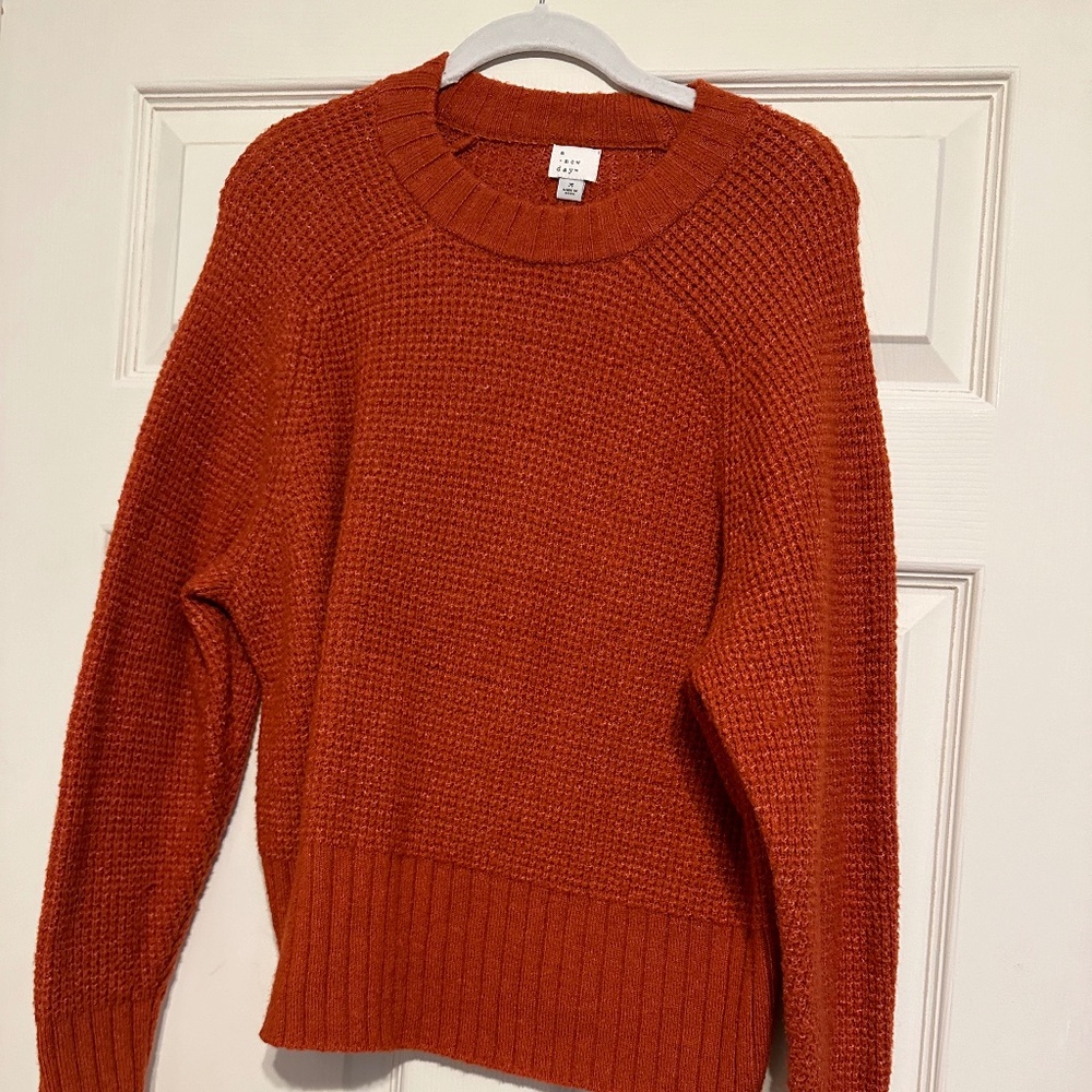 Warm, dark orange sweater